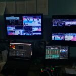 A production monitor showing the live PBA broadcast during a behind-the-scenes production setup.