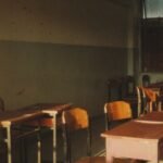 An empty classroom with sunlight streaming through the windows.